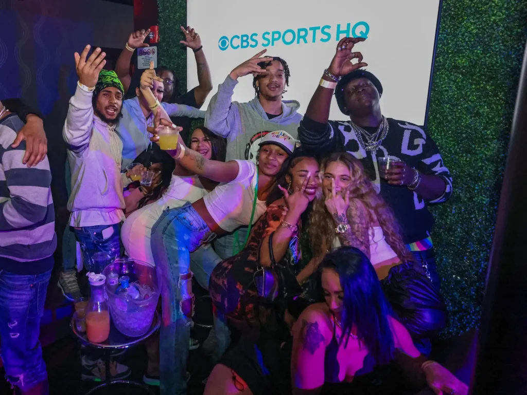 Bachelorette party guests celebrating under green lights at Controversy Pittsburgh