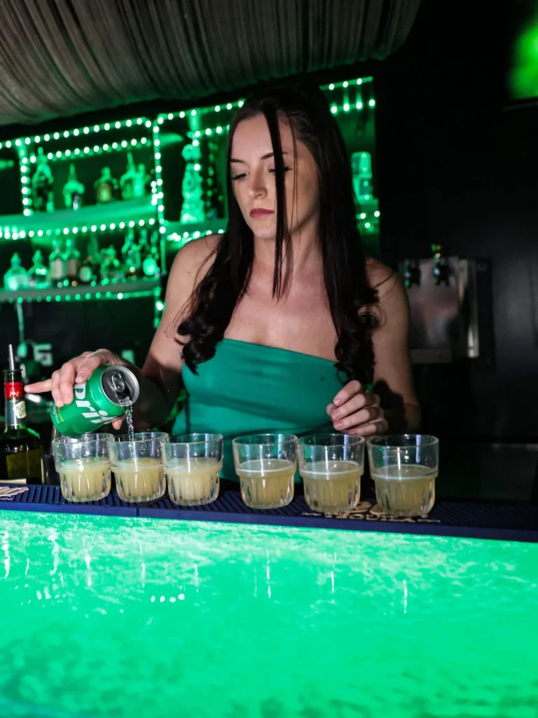 Bartender pouring a round of shots at the bar at Controversy nightclub Pittsburgh